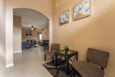 Inviting entry hallway with seating area leading to open living space in a Central Florida vacation rental near Disney.