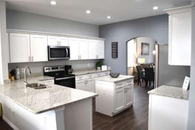 Fully equipped kitchen with island and granite countertops.
