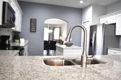 Kitchen island sink with granite countertops.