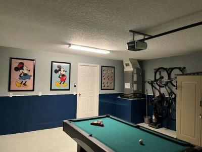 Game room with pool table and wall art.