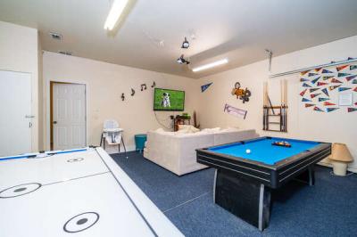 Sports themed games room showing TV pool table, and air hockey table