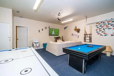 Sports themed games room showing TV pool table, and air hockey table