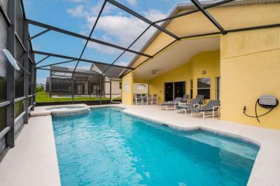 View of back of home with  covered lanai and seating
