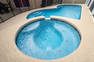 close up view of spa and pool with pool security fence