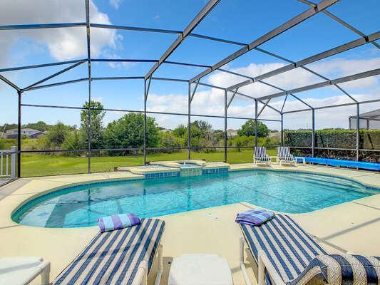 Sun loungers overlooking a beautiful pool and view