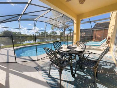 Pool area showing outdoor dining table with seating for 4