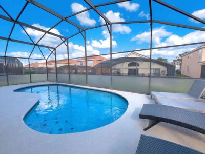 Screened in private pool area showing sun loungers
