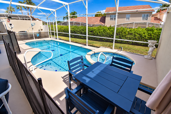 Pool area showing outdoor dining table seating for 4