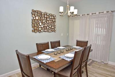 Dining table and patio doors to pool area.