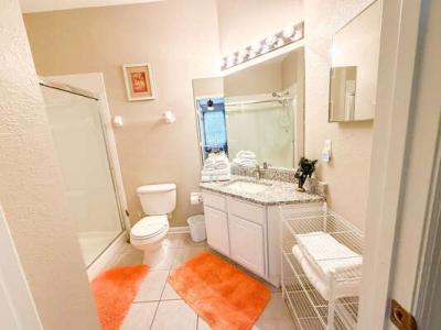 Master en-suite bathroom showing toilet and shower entrance.