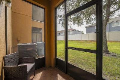 Screened porch with seating.
