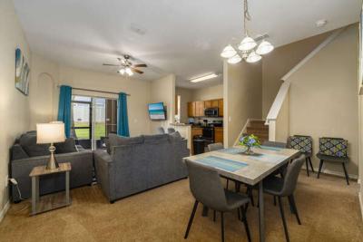 Living area showing dining table, and sofa seating.