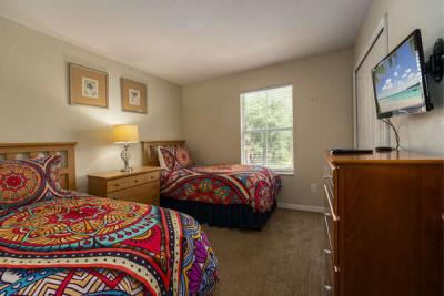 Twin bedroom showing tv.