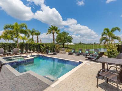 The pool area features multiple seating areas and 6 sun loungers
