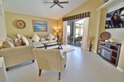 Lounge with flatscreen TV and patio doors to pool