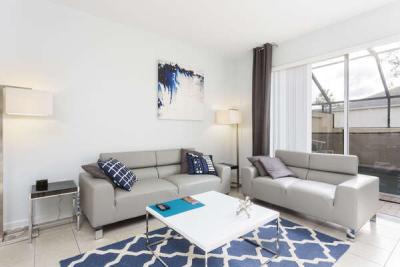 The living space is modern and contemporary with sliding glass doors out to the pool