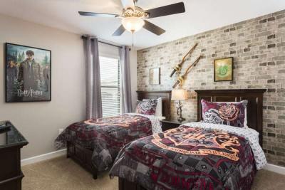 This kids bedroom has two twin beds and a flatscreen TV