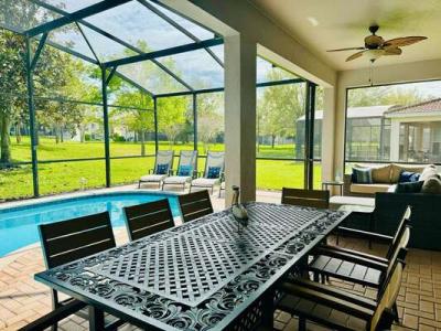 Dine al fresco underneath the covered lanai with seating for 8 and two ceiling fans for those hot summer days