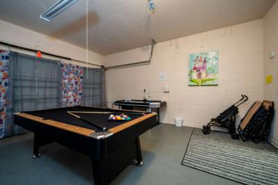 Game room showing pool table, and air hockey table