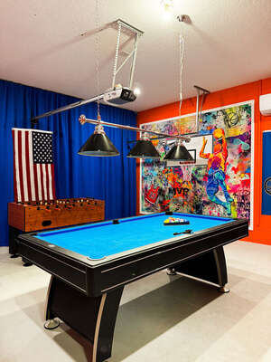Garage conversion to sporty games room showing pool table and foosball.