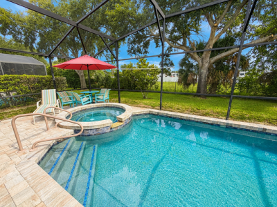 Screened in private pool showing shaded dining table seating for 4.