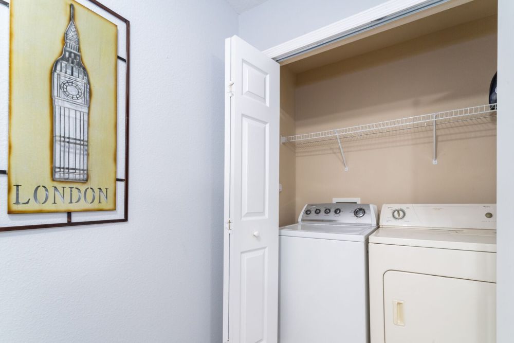 Laundry closet with washer and dryer.