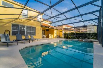 Private screened swimming pool with spacious deck seating and attached spa, offering plenty of room to relax and unwind outdoors.