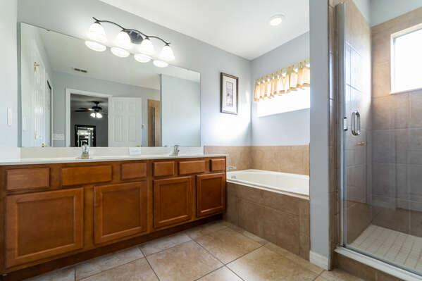 Master en-suite bathroom with double sink vanity, soaking tub, and walk in shower.