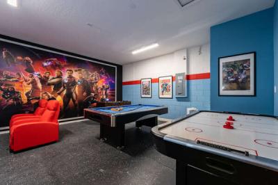 Themed games room showing air hockey and pool table
