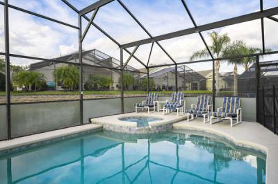 Pool and waterfall spa showing seating and view