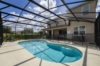 Pool view showing screened enclosure and child safety fence