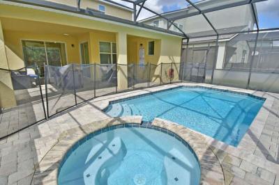 View of pool and spa showing safety fence