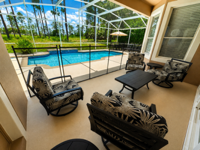 Pool area showing comfortable seating  area and pool safety fence.