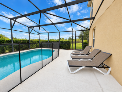 Pool deck showing sun loungers and pool fence
